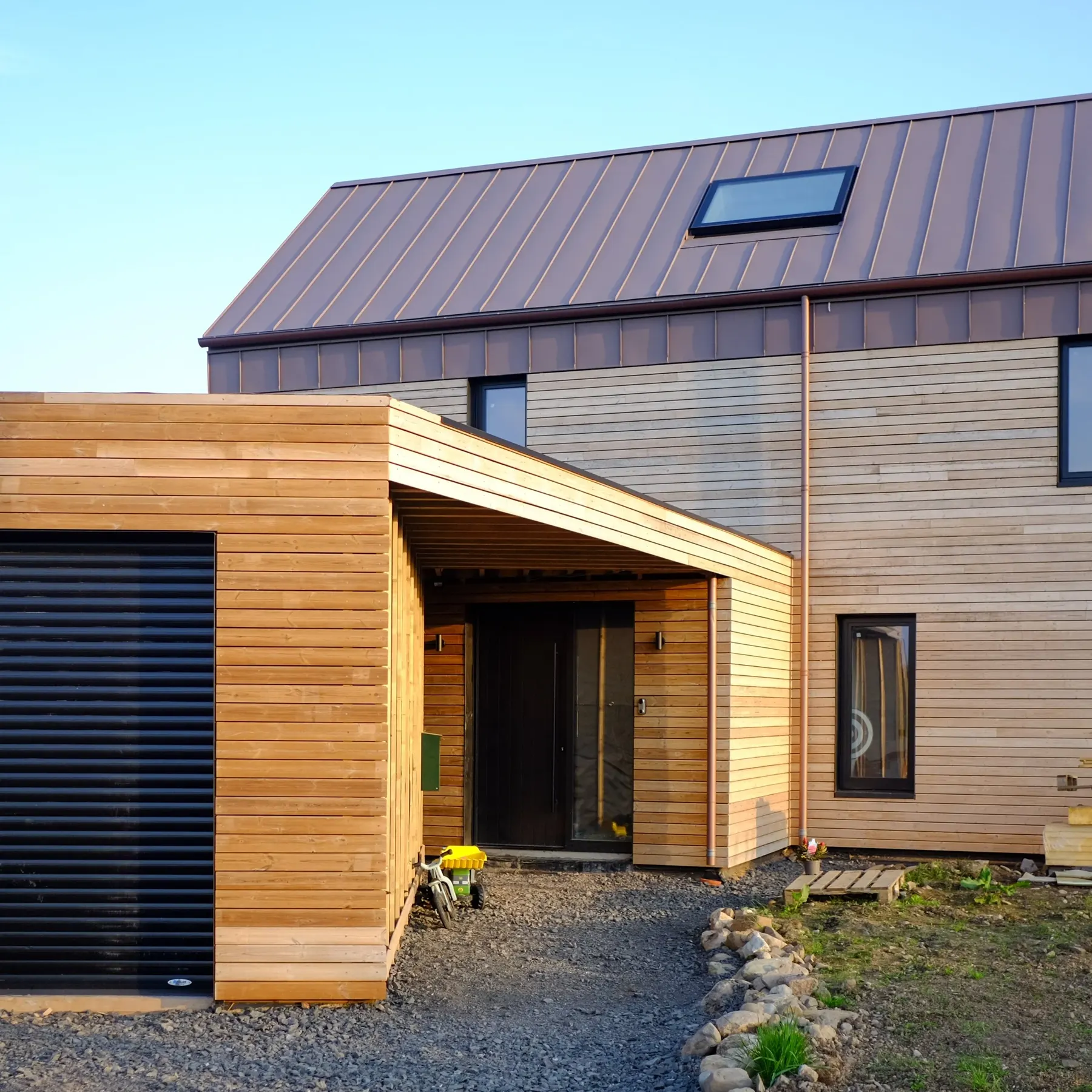 Entrance porch and garage of the Perthshire house, clad in thermal pine